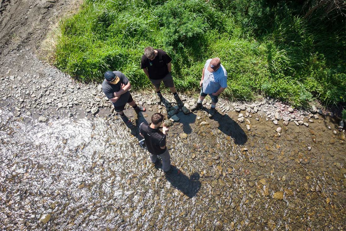 Water quality experts and farmers checking on stream health in the Tararua region.