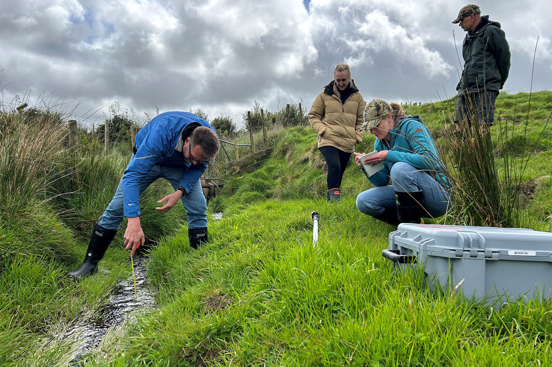 Farmers helping select stream sampling sites and carrying out sampling.