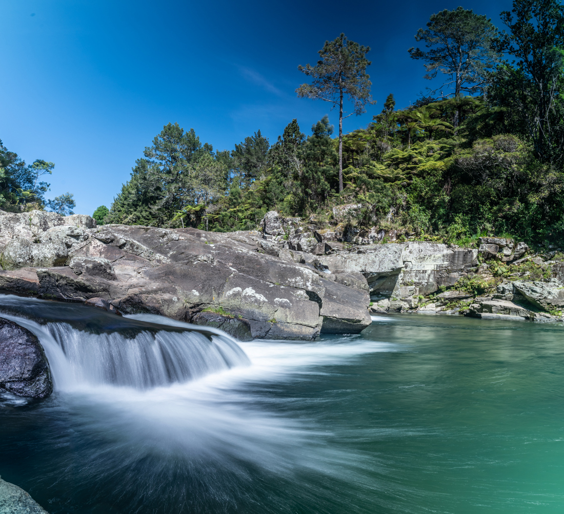 A river surrounded with big rocks