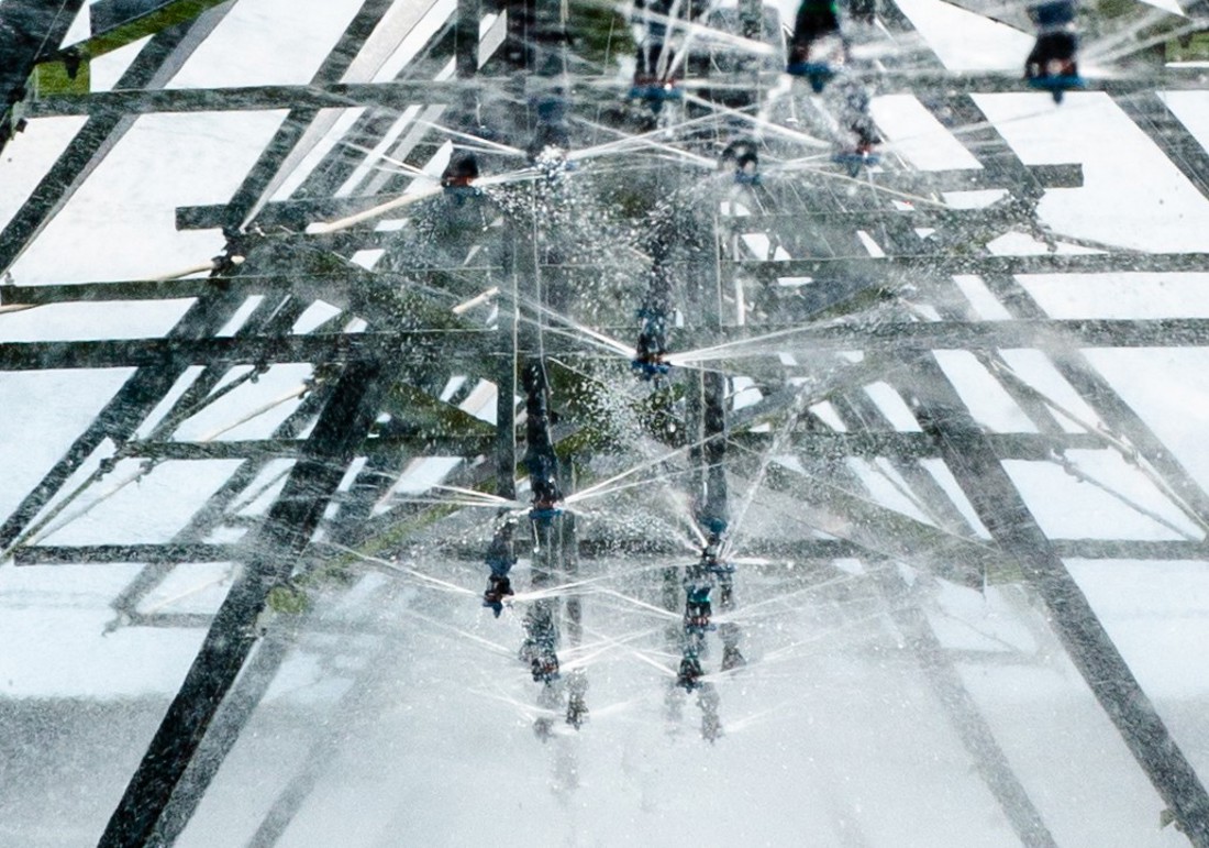 Abstract photo taken from underneath an irrigation system with water spraying out