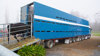 A blue truck transporting a cattle