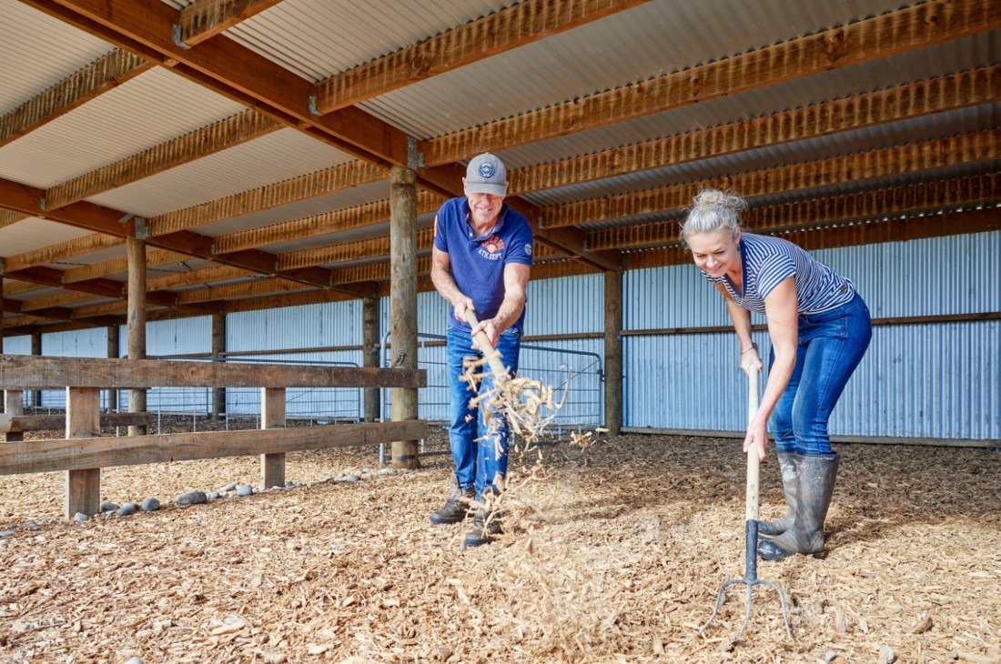 A dairy farming couple setting up calf pens in preparation for calving season
