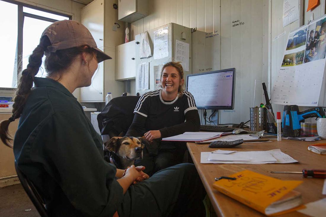New farm employee enjoying a catchup in the farm office with her employer.