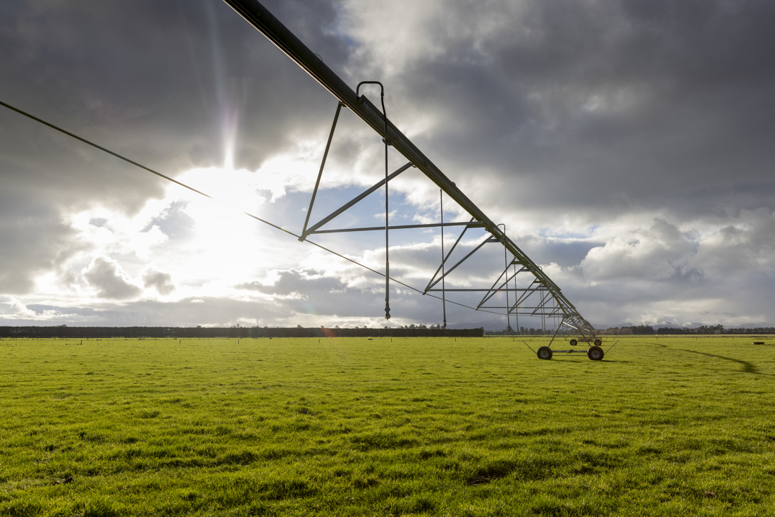 An open field with a water sprinkler