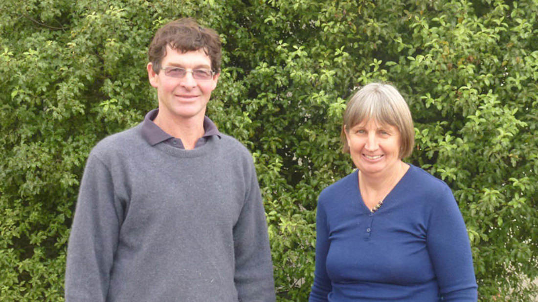 two person standing in front of trees