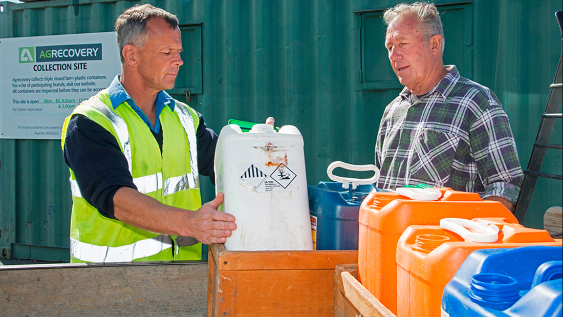 Two men looking at a container